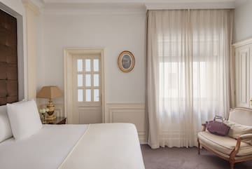 a bedroom with a bed and a chair