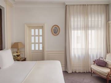 a bedroom with a bed and a chair
