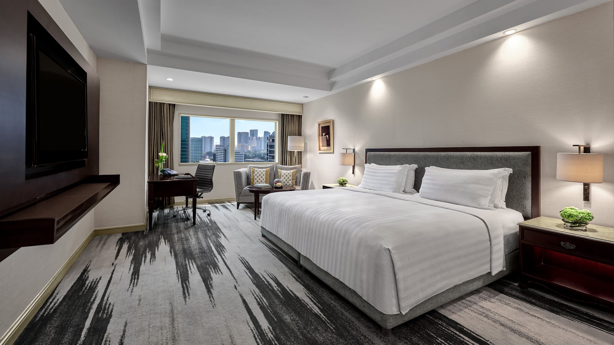 a hotel room with a desk and a chair