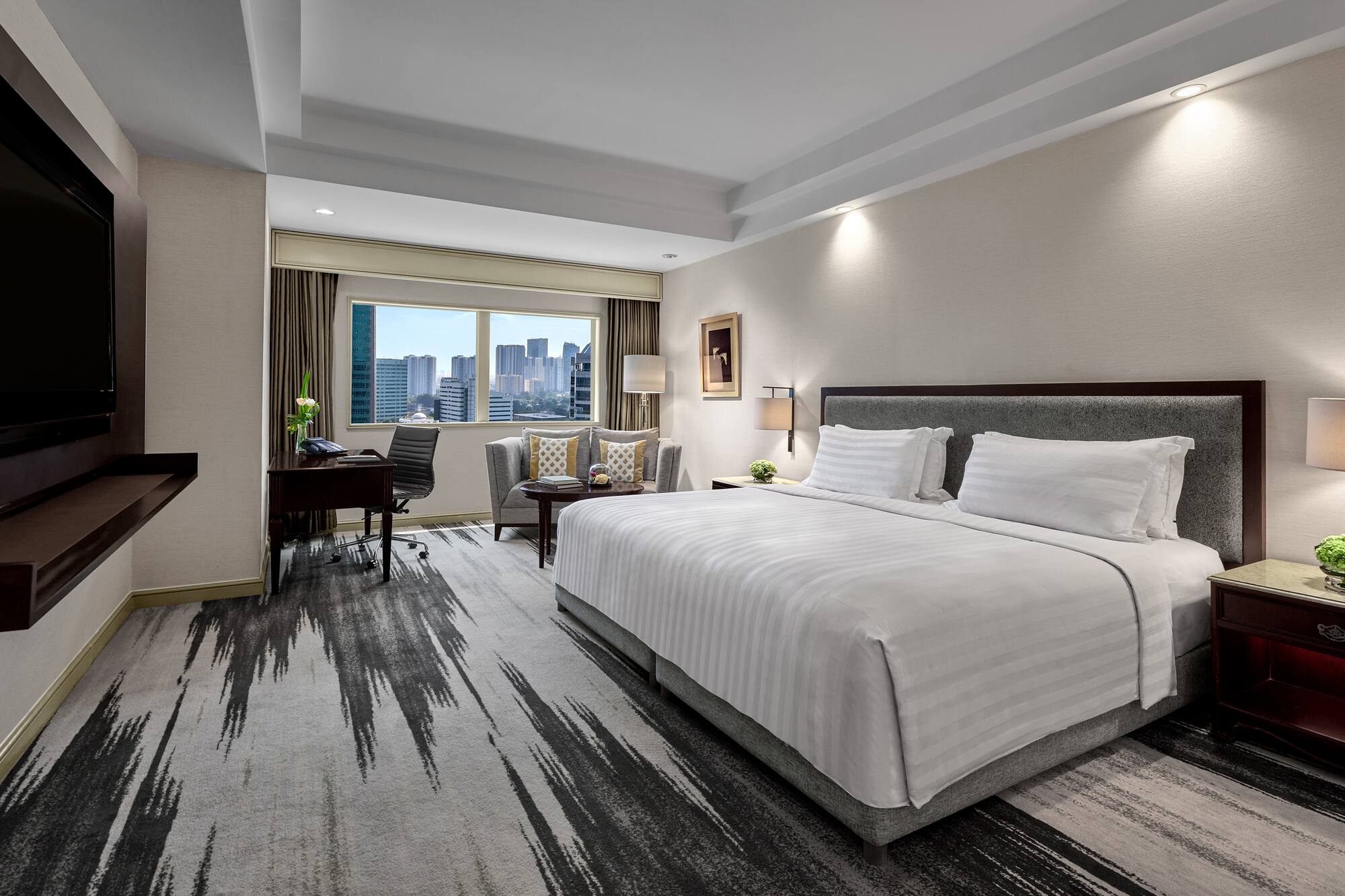 a hotel room with a desk and a chair