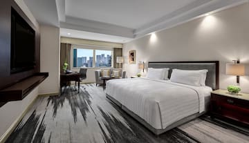 a hotel room with a desk and a chair