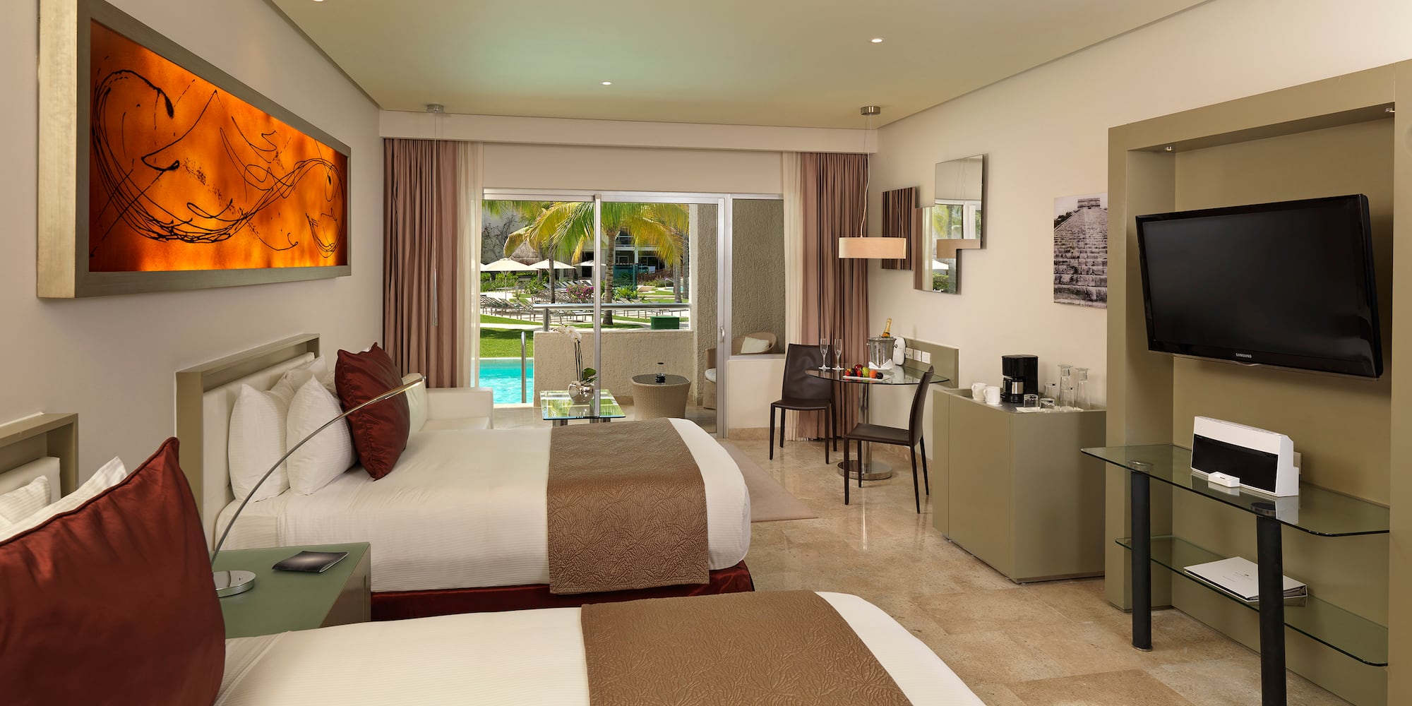 Hotel room with two beds, pool view balcony, TV, and contemporary decor.