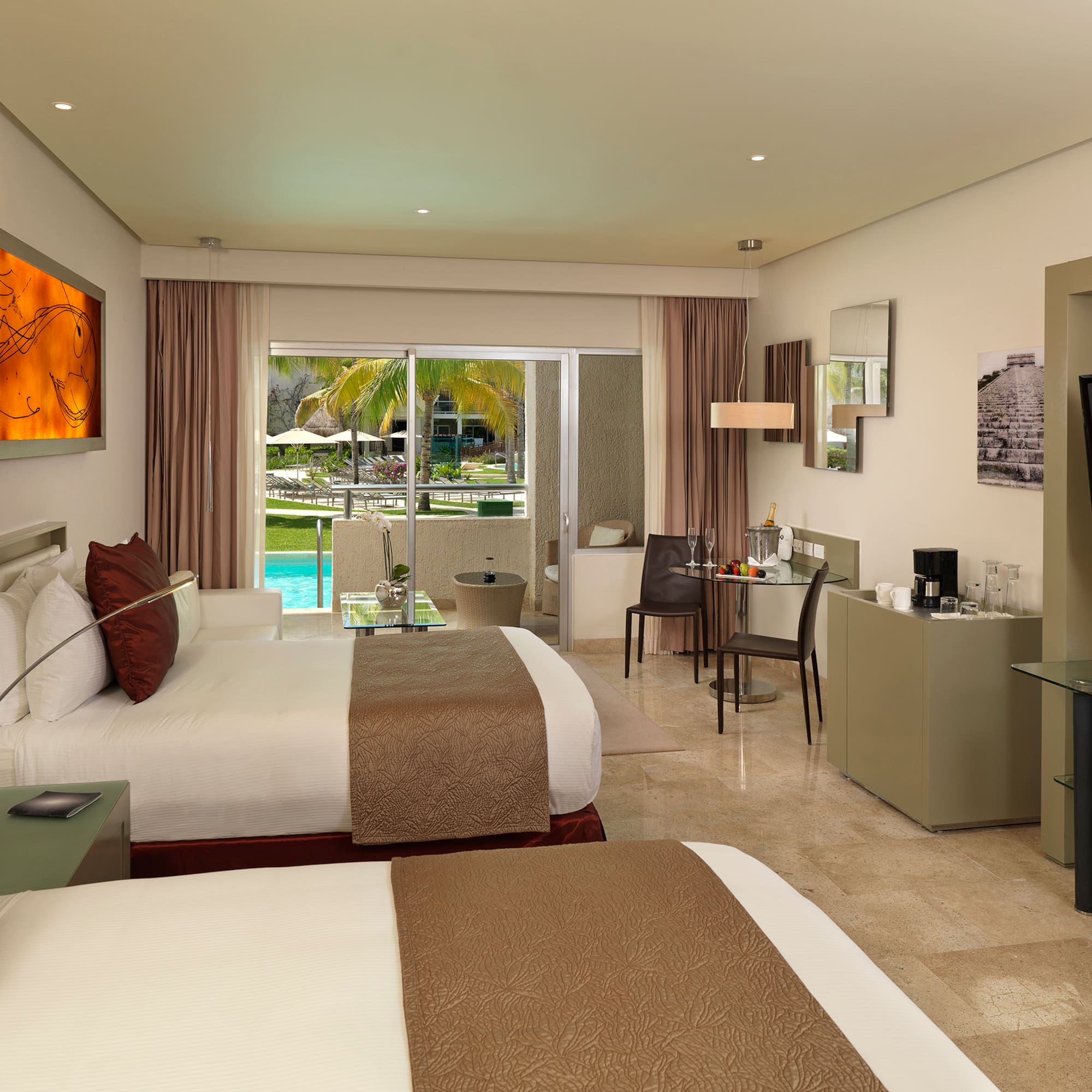 Hotel room with two queen beds, private balcony, and tropical pool view.