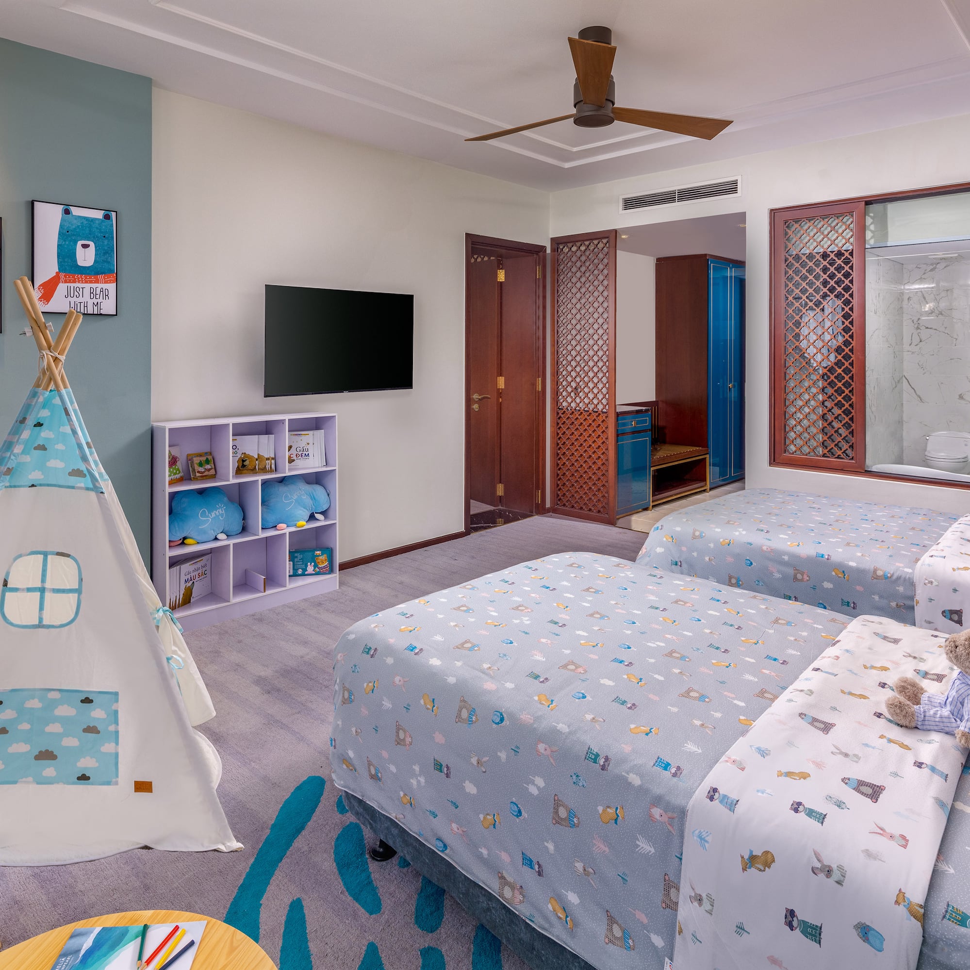 a room with two beds and a teepee