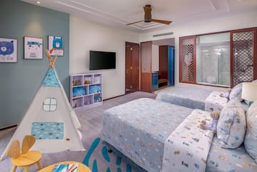 a room with two beds and a teepee