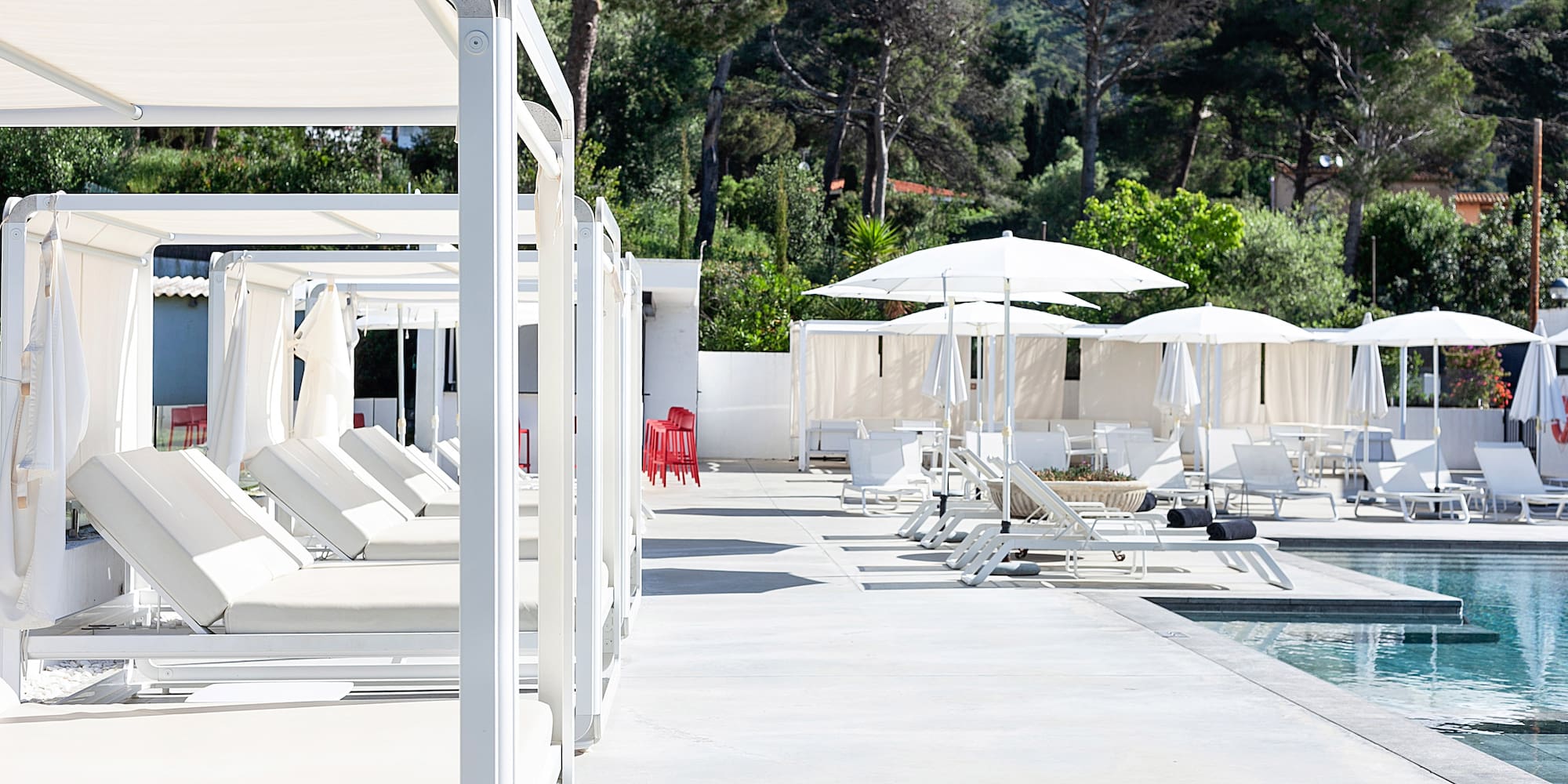 a pool with lounge chairs and umbrellas