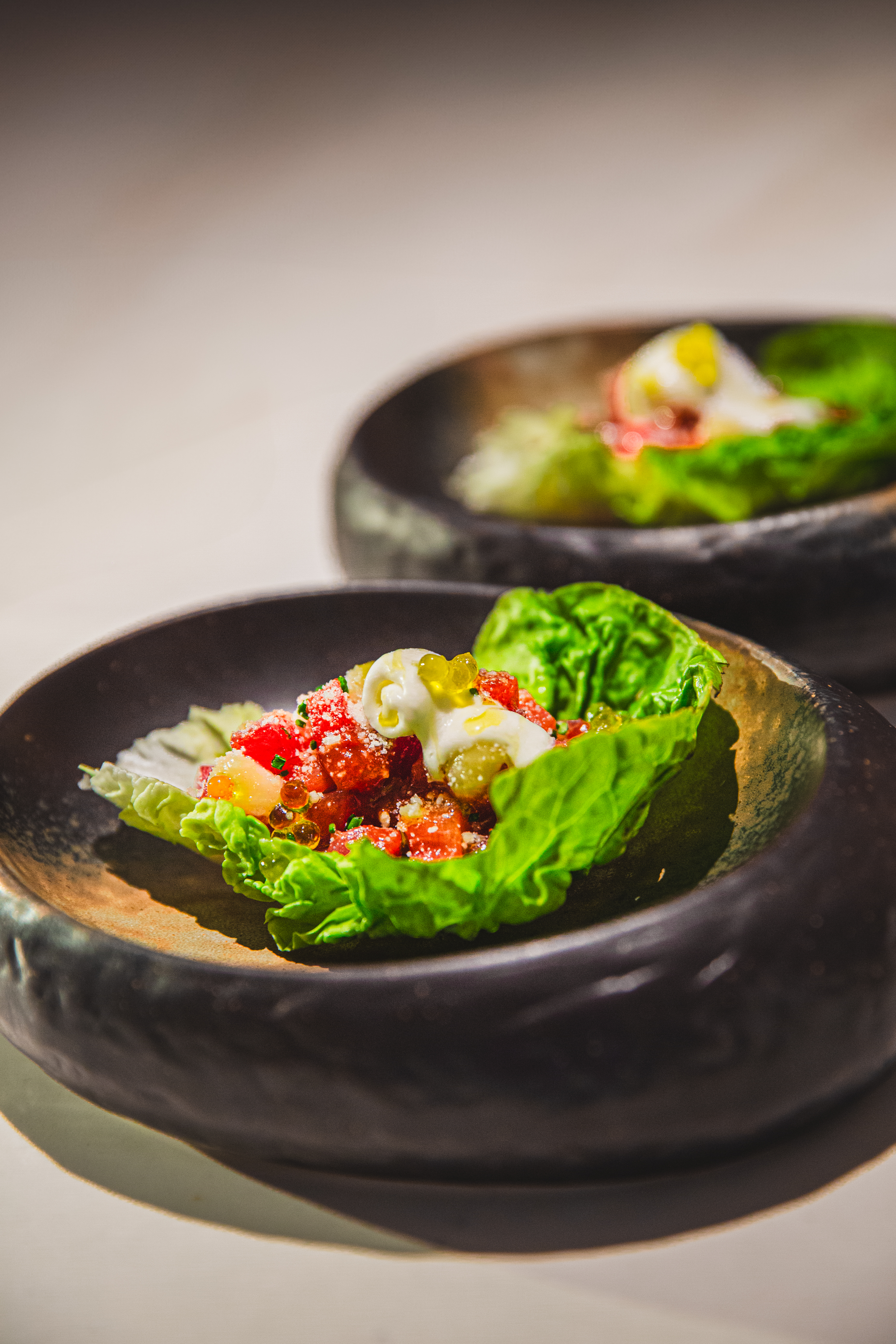 Fresh lettuce wraps with red tartare, creamy topping, and colorful roe.