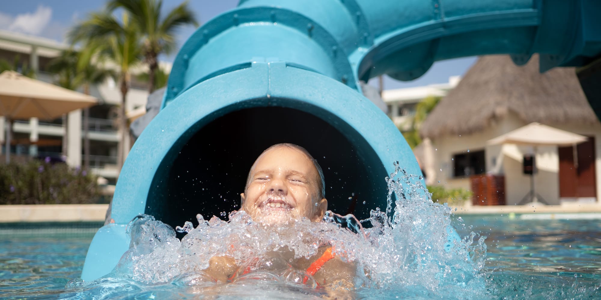 a child in a pool with a tube