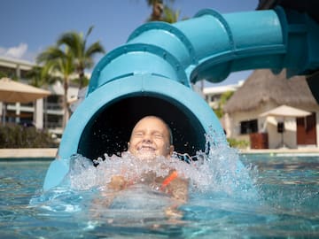 a child in a pool with a tube
