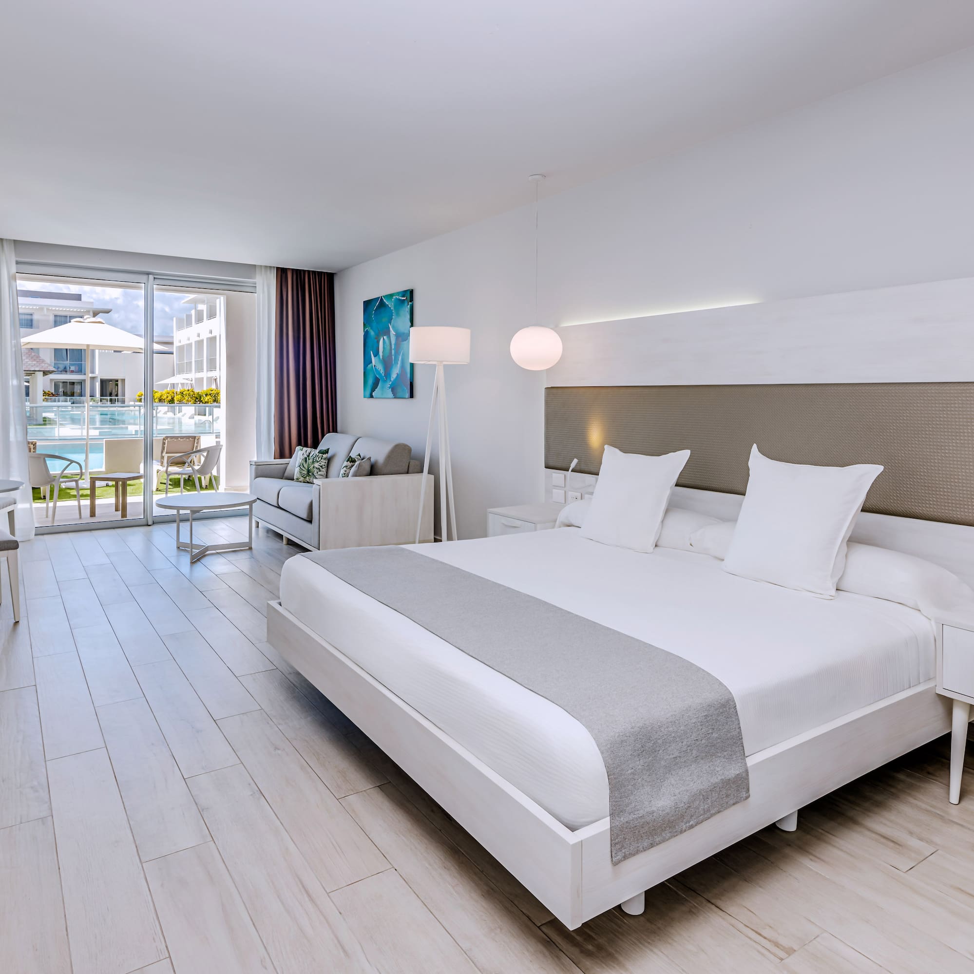 a room with a bed and a table and chairs