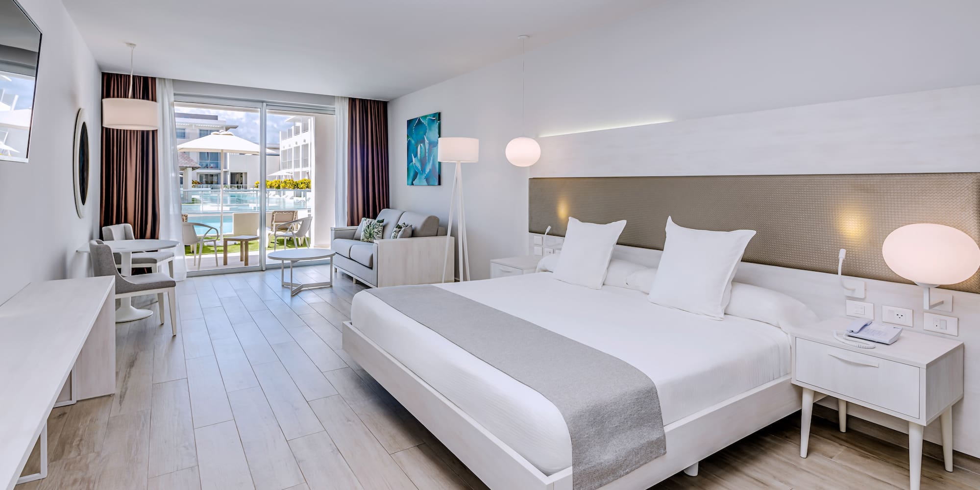 a room with a bed and a table and chairs