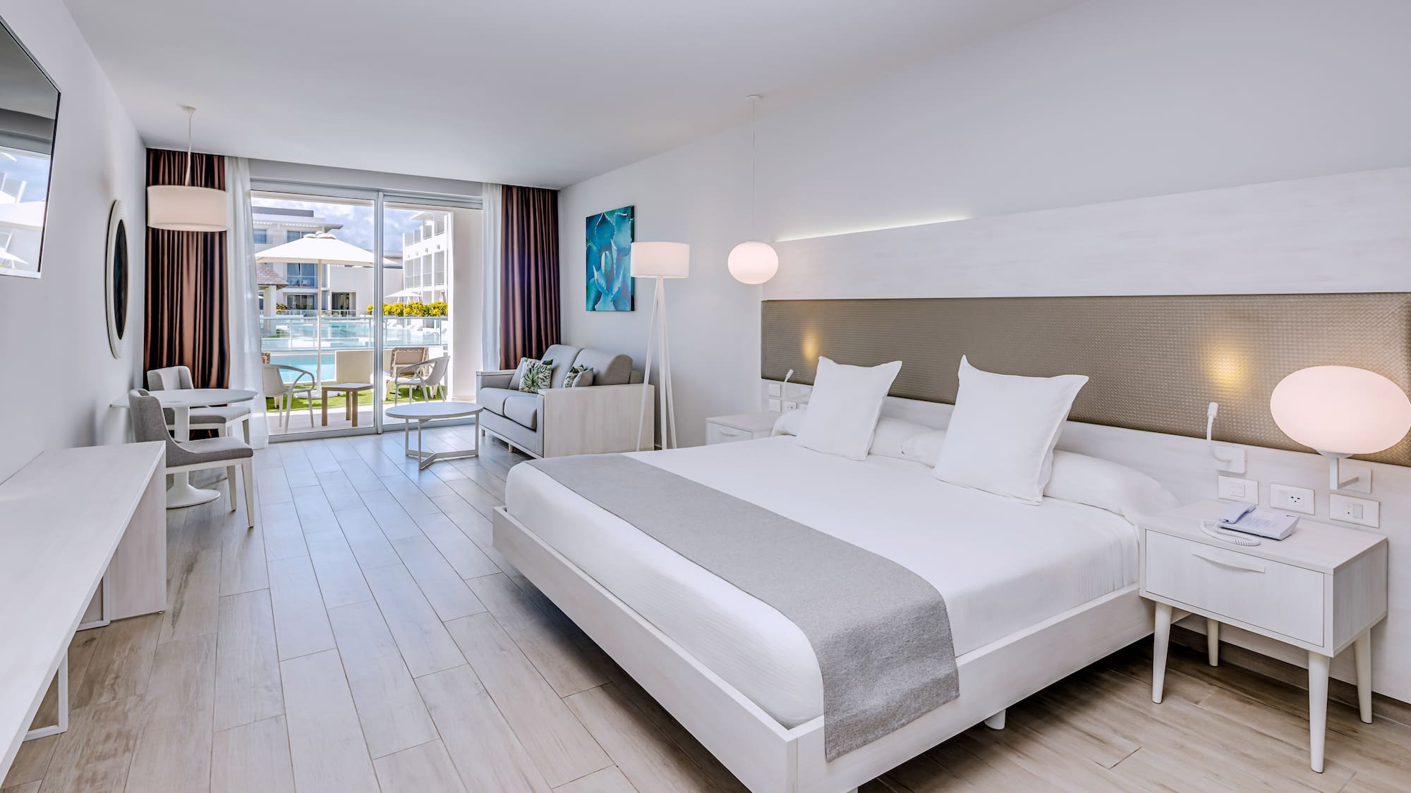 a room with a bed and a table and chairs