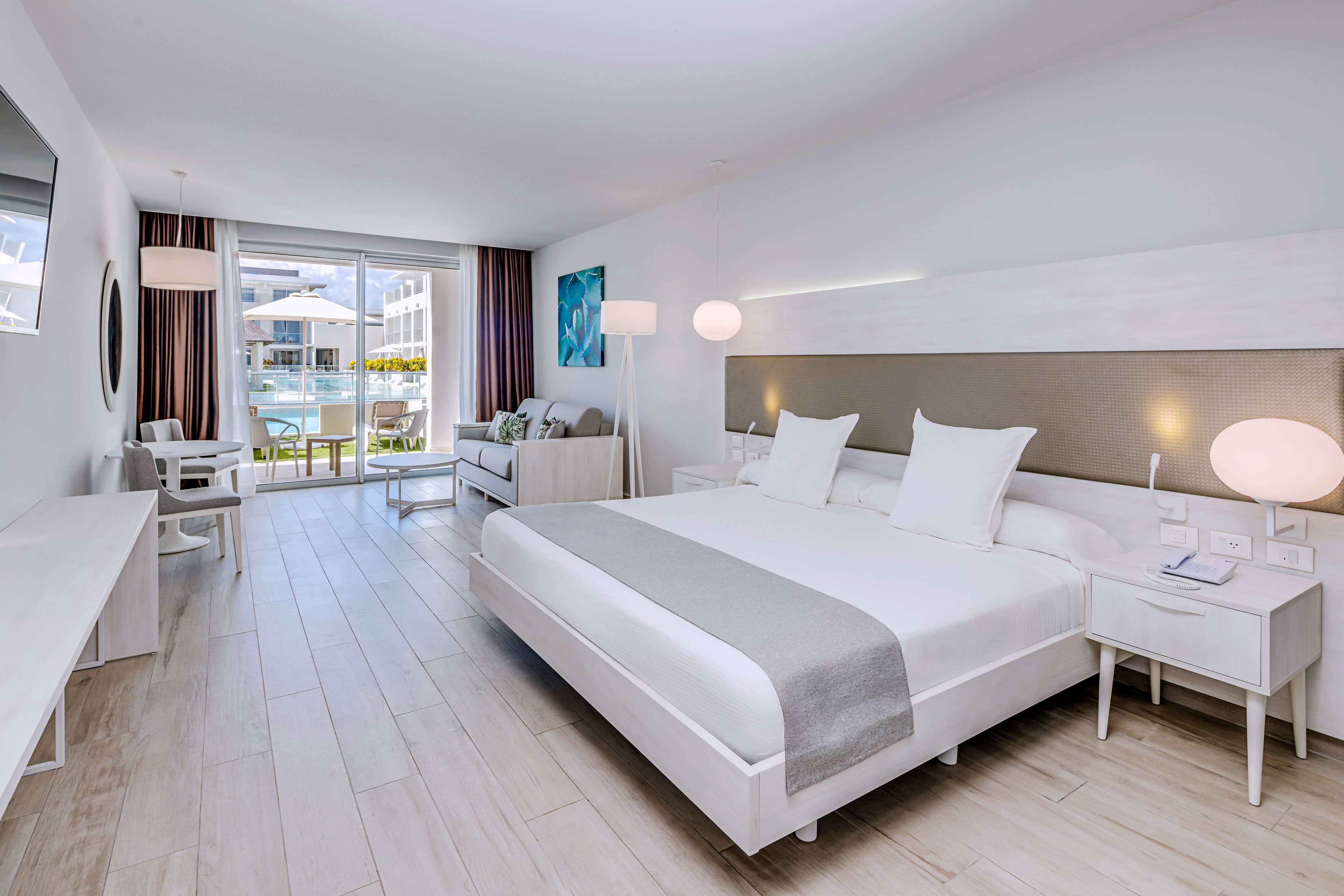 a room with a bed and a table and chairs