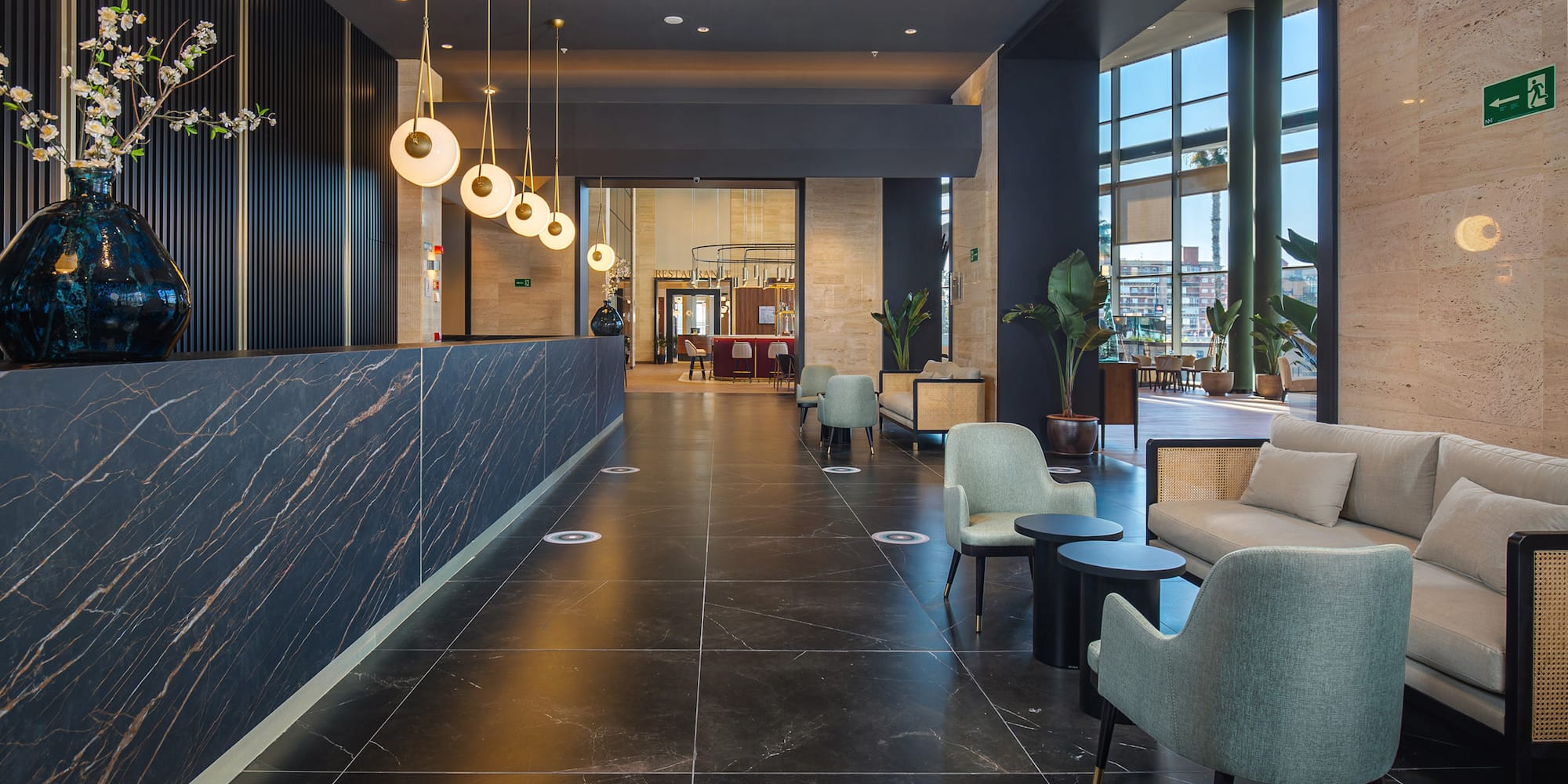 a lobby with a reception desk and chairs