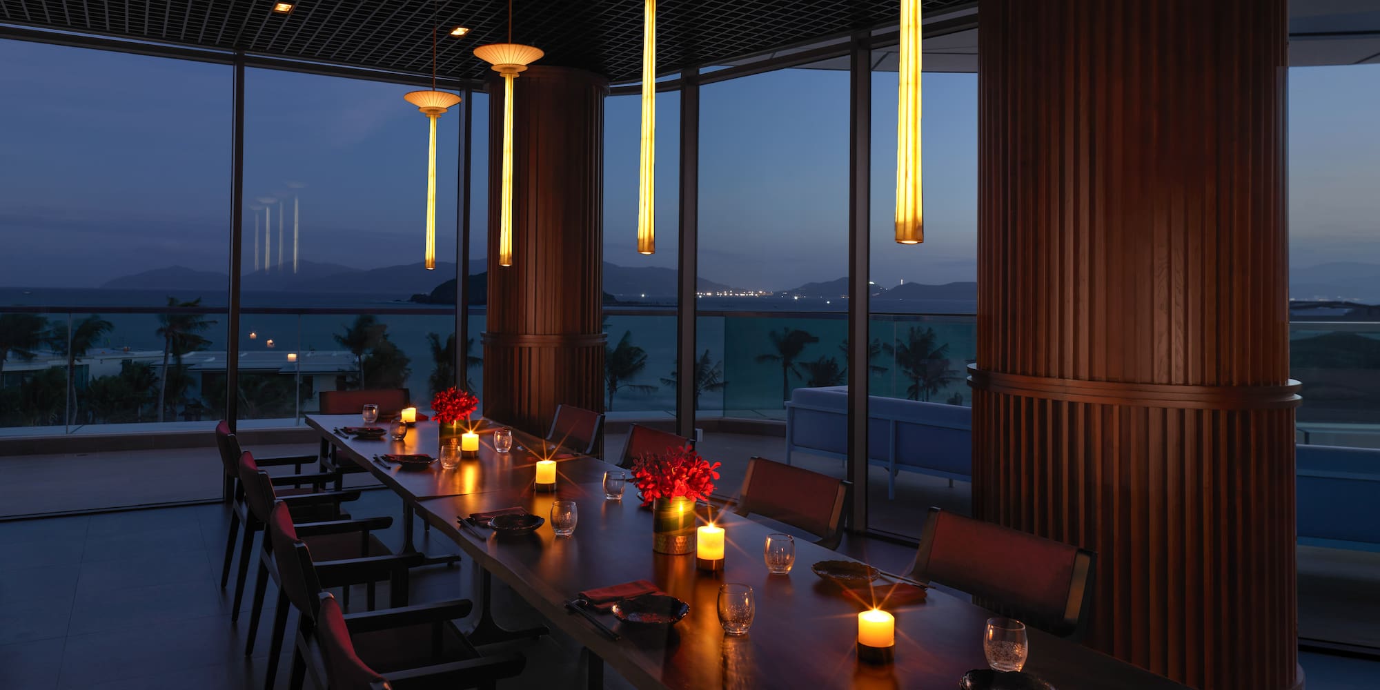 a long table with candles and flowers on it