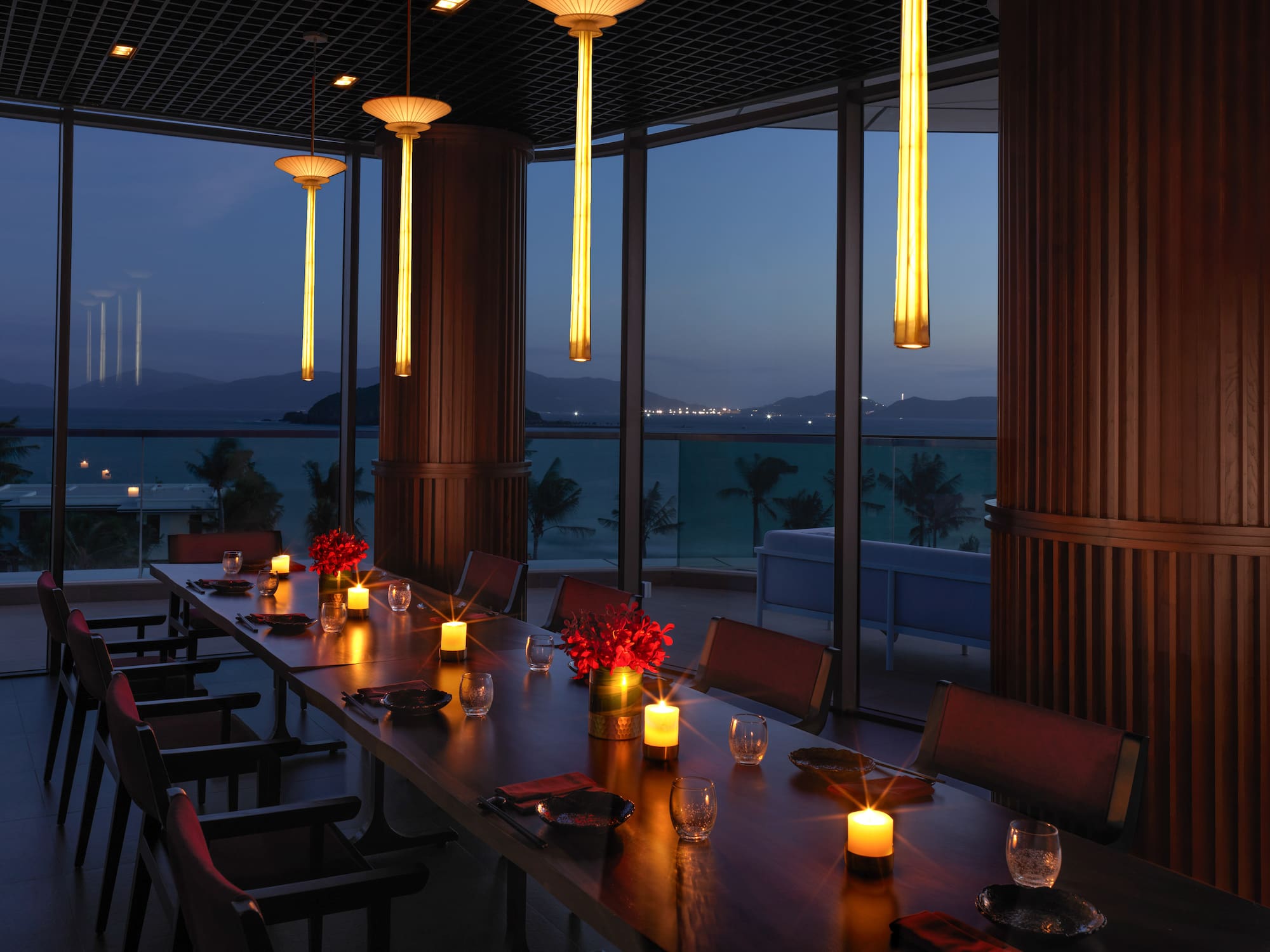 a long table with candles and flowers on it