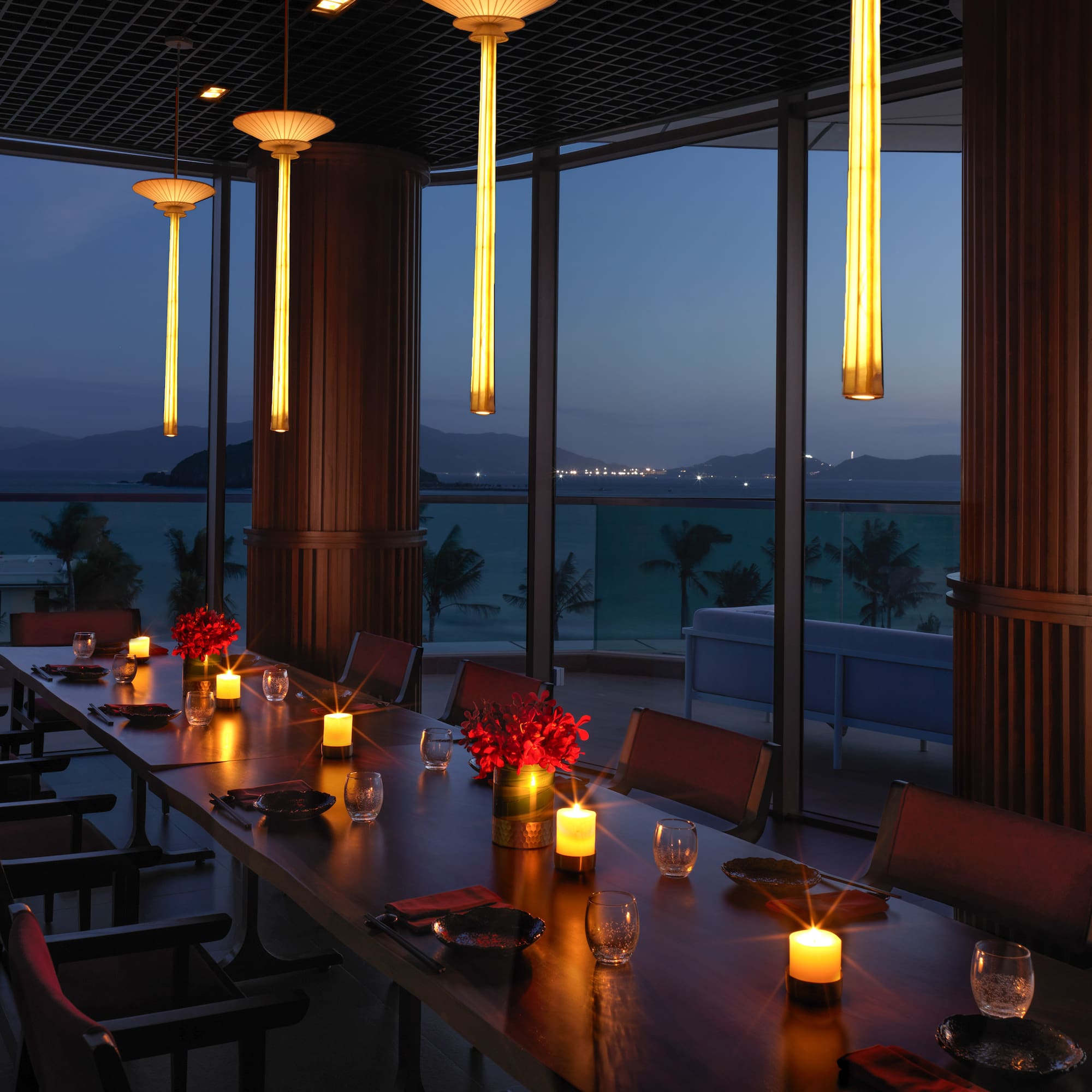 a long table with candles and flowers on it