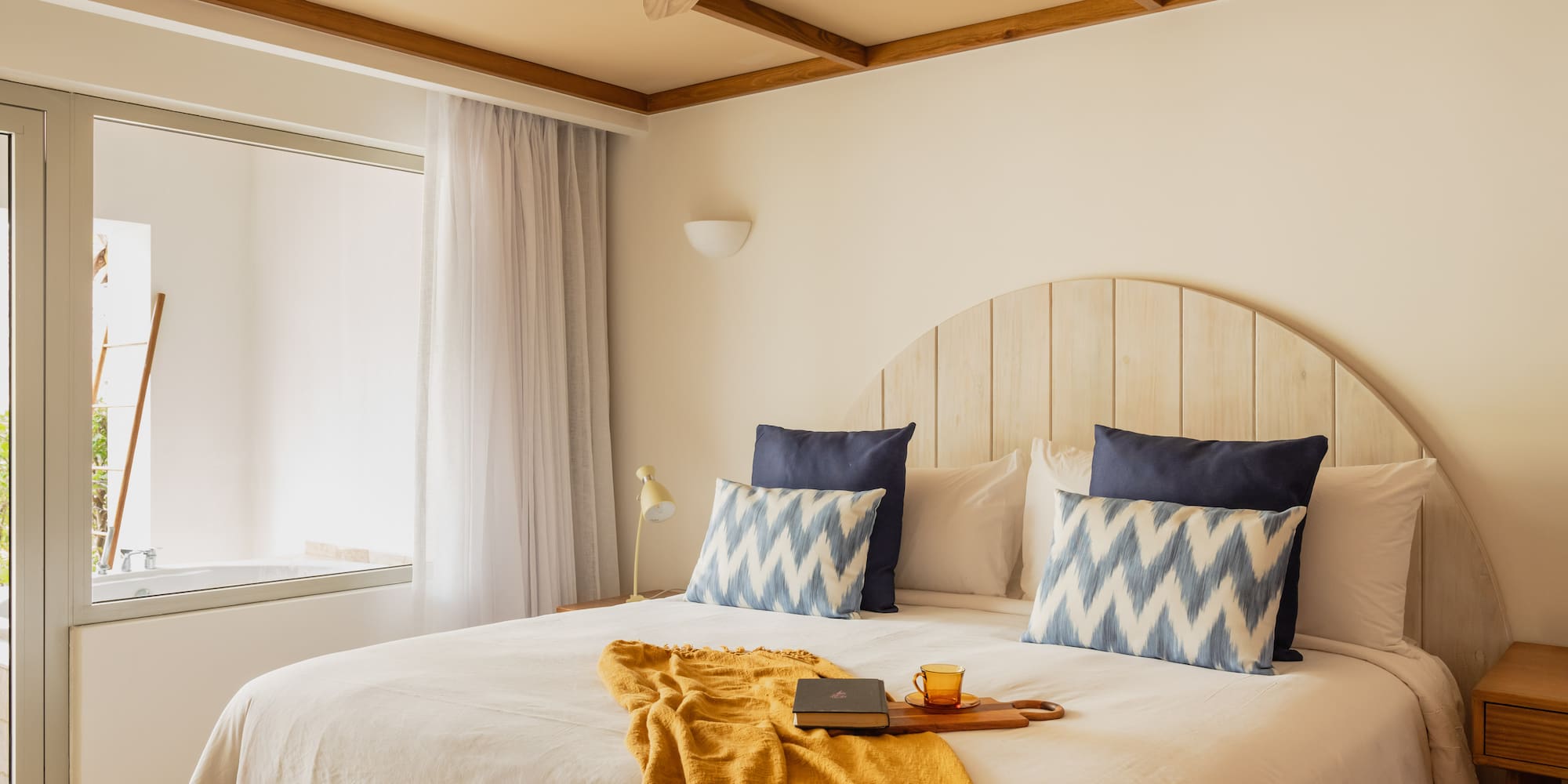a bed with a fan and a book on it