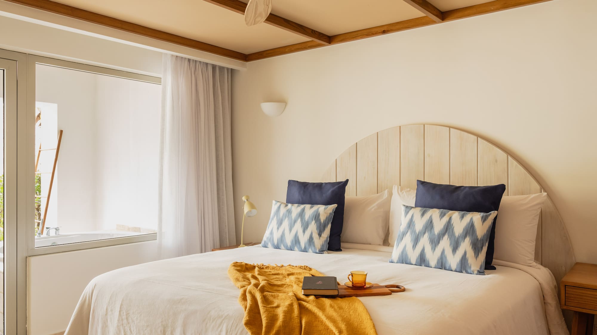 a bed with a fan and a book on it