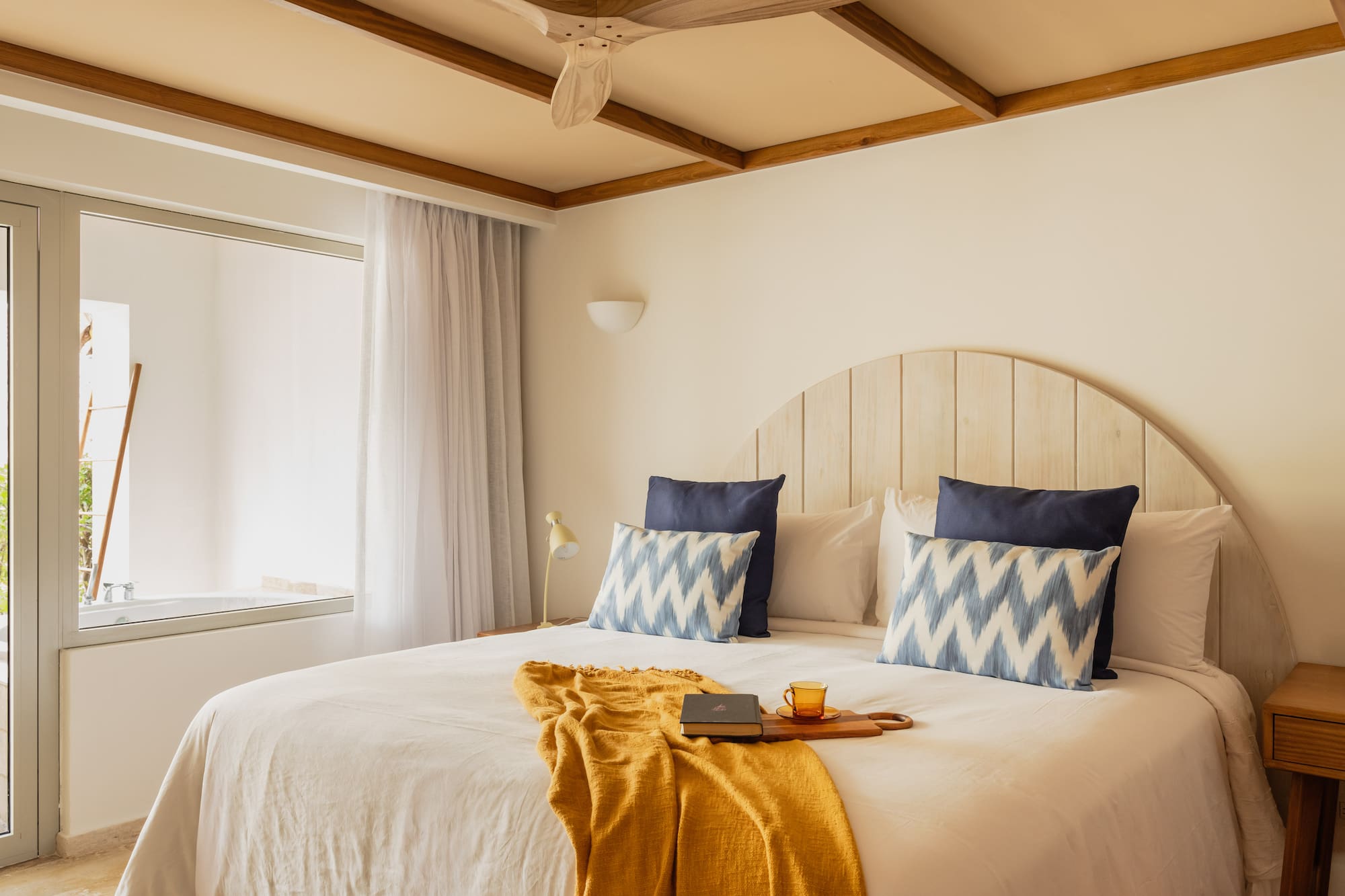 a bed with a fan and a book on it