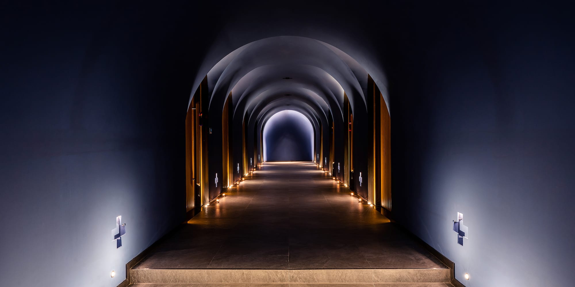 a hallway with lights on the walls