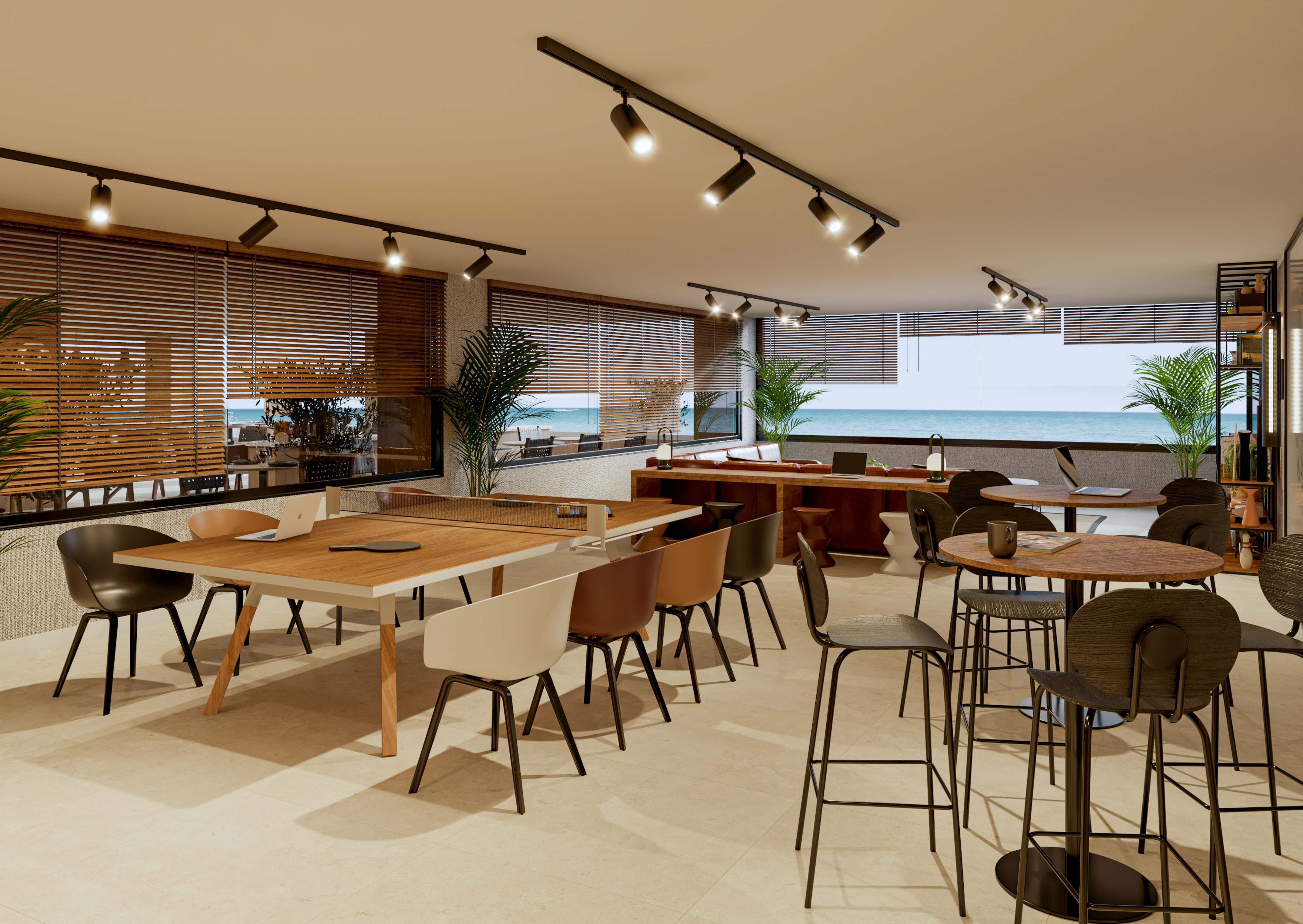 Modern co-working office with ocean view, collaborative tables, and lounge seating.