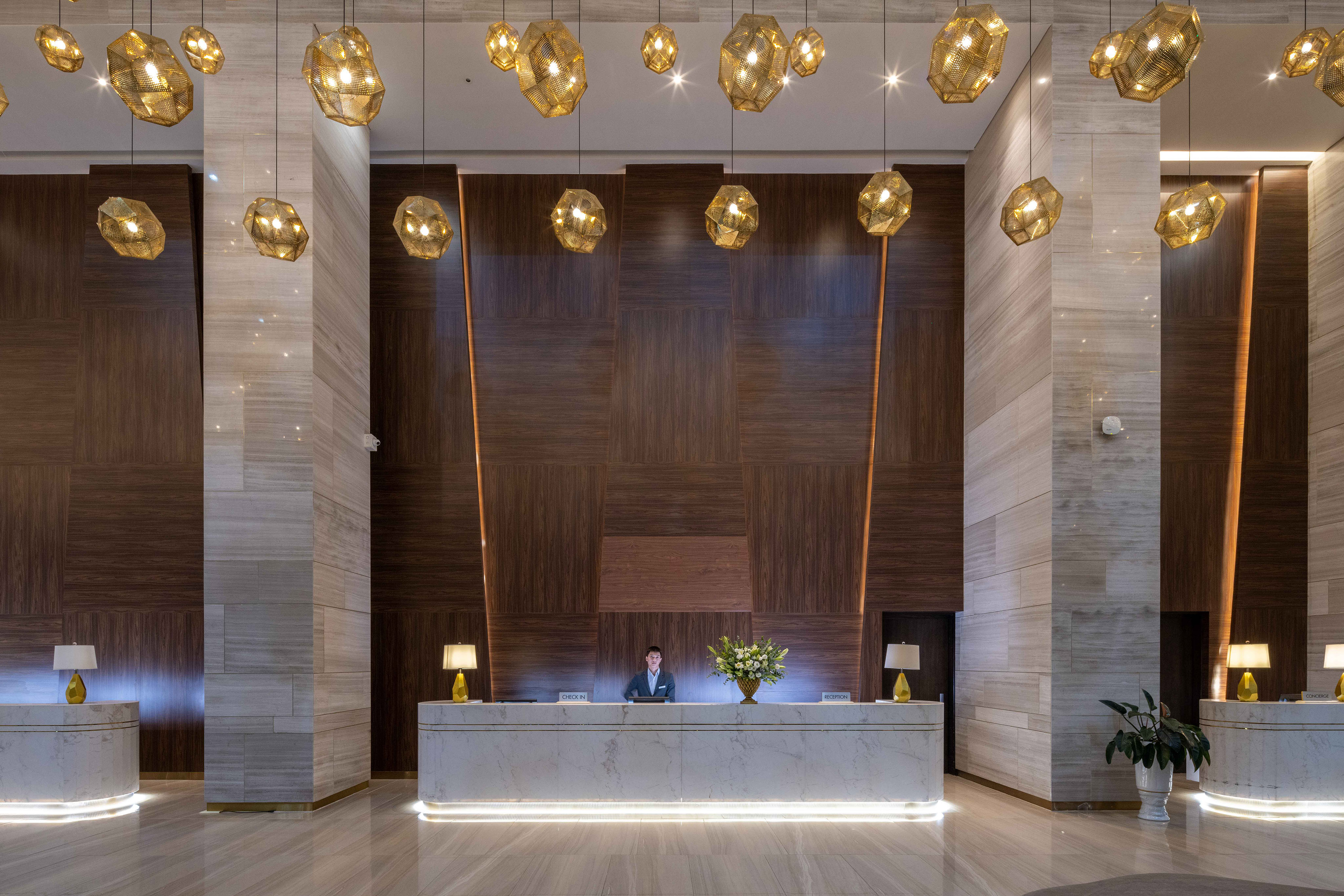 a man at a reception desk in a hotel