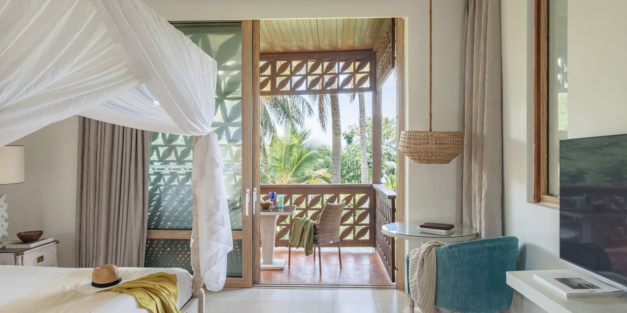 a room with a bed and a table and chairs