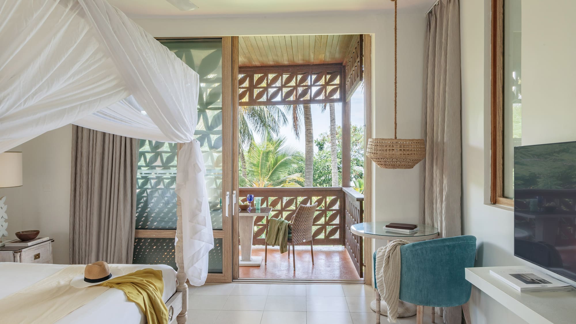 a room with a bed and a table and chairs