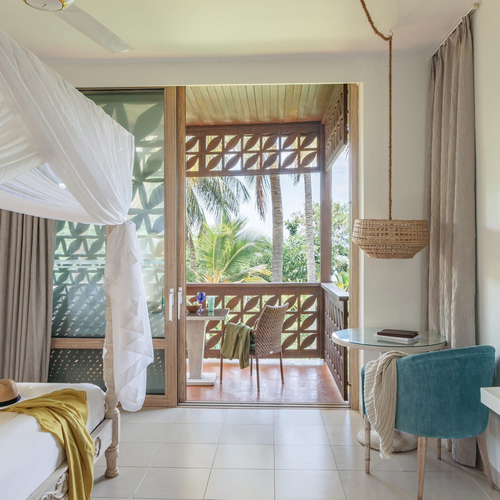 a room with a bed and a table and chairs