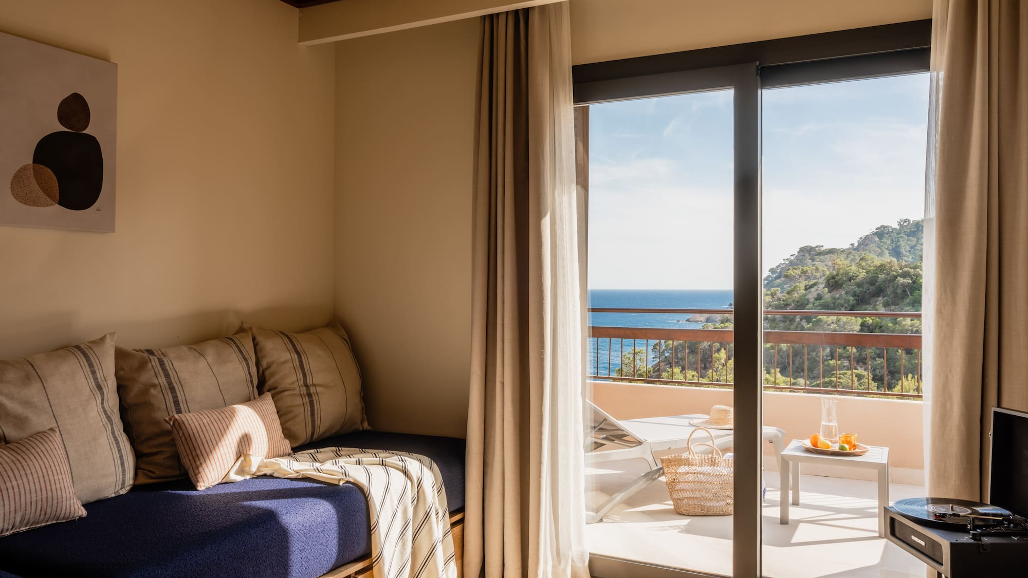 a room with a bed and glass doors