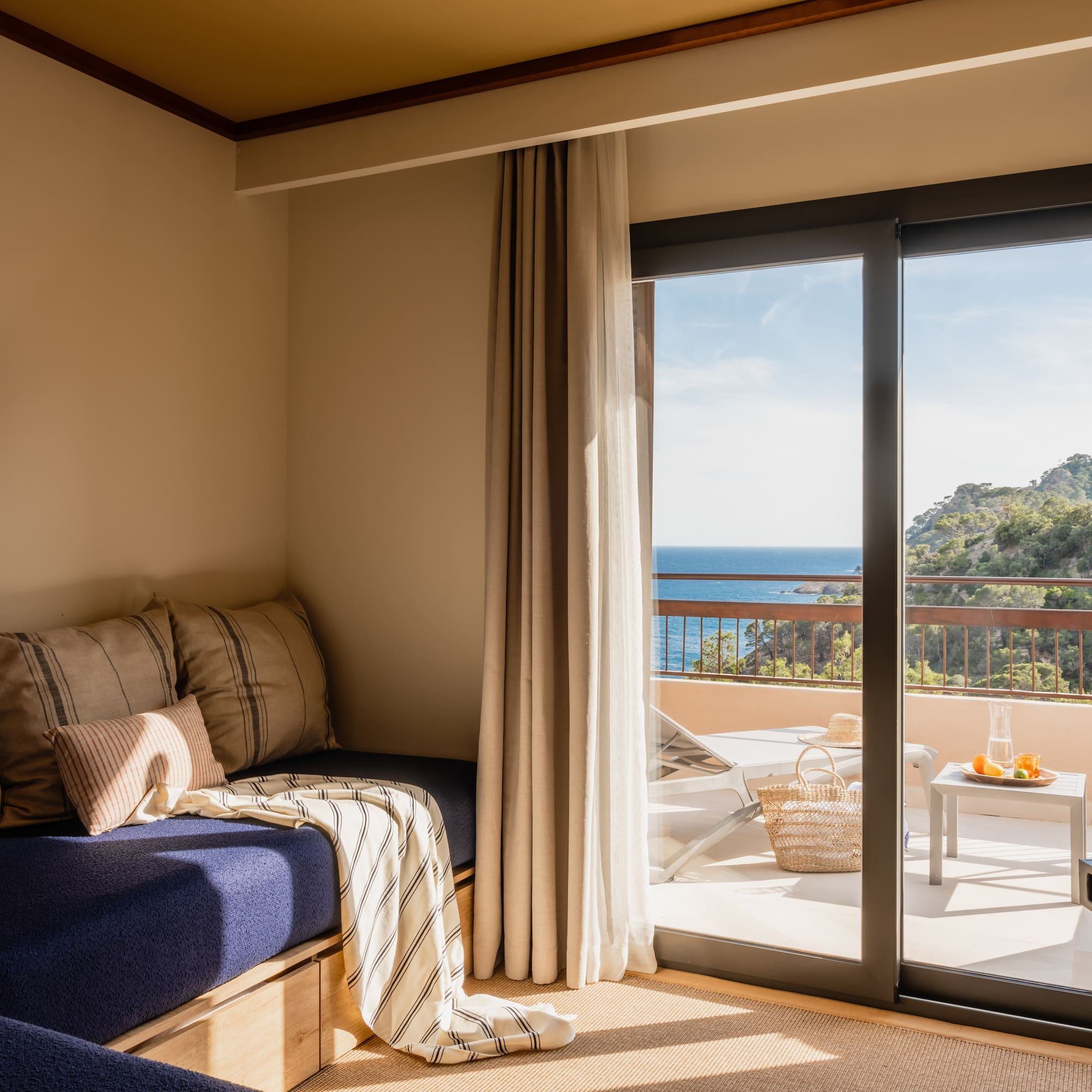 a room with a bed and glass doors
