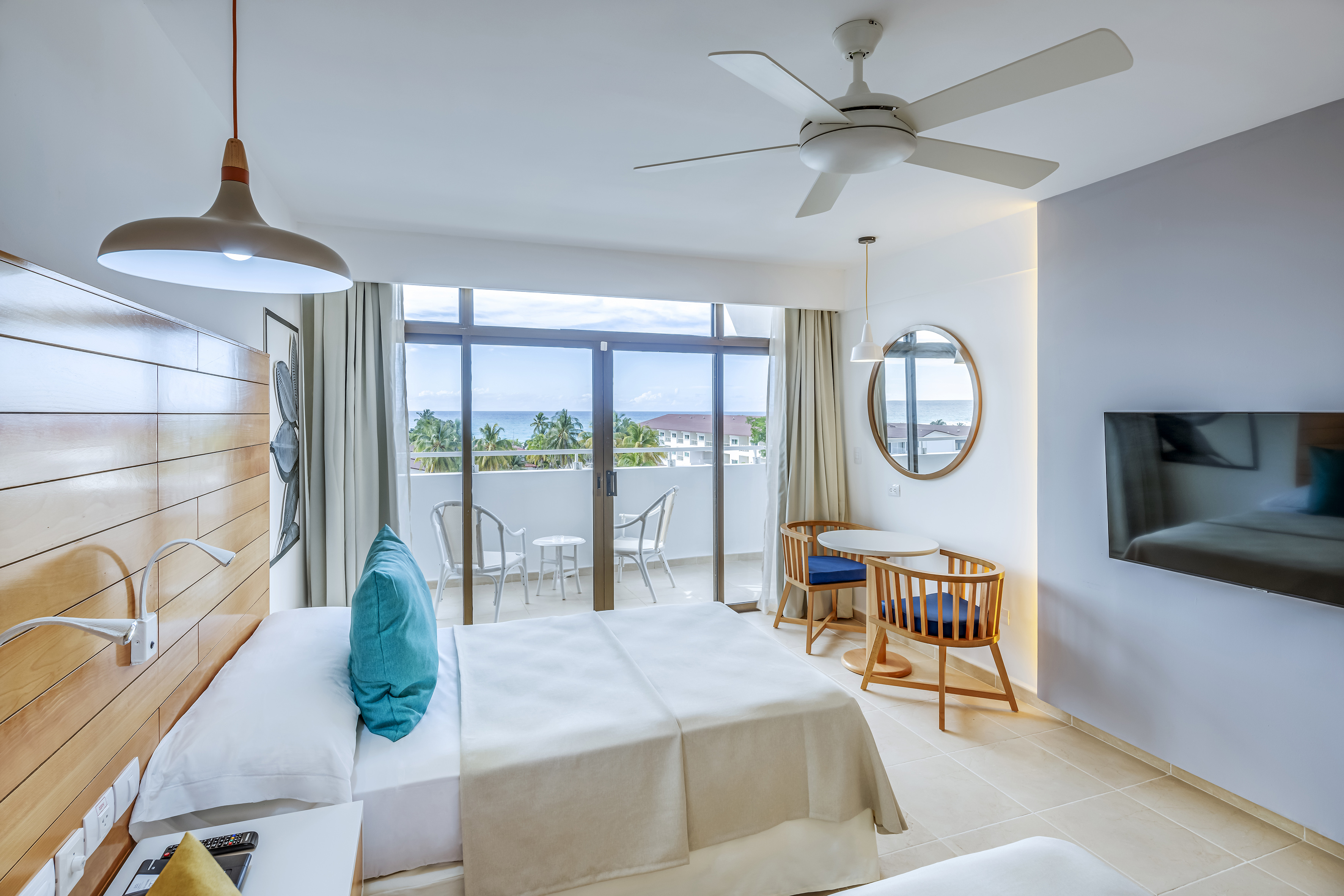 a room with a bed and a television