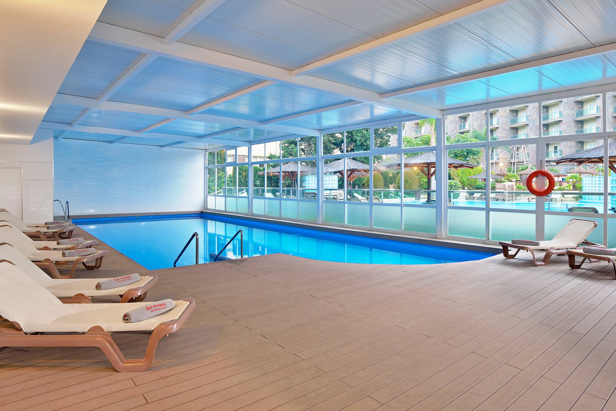 a pool with chairs and a deck chair