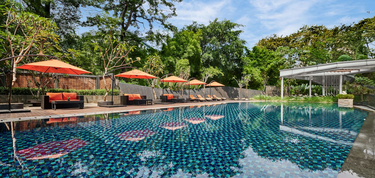 a pool with umbrellas and chairs