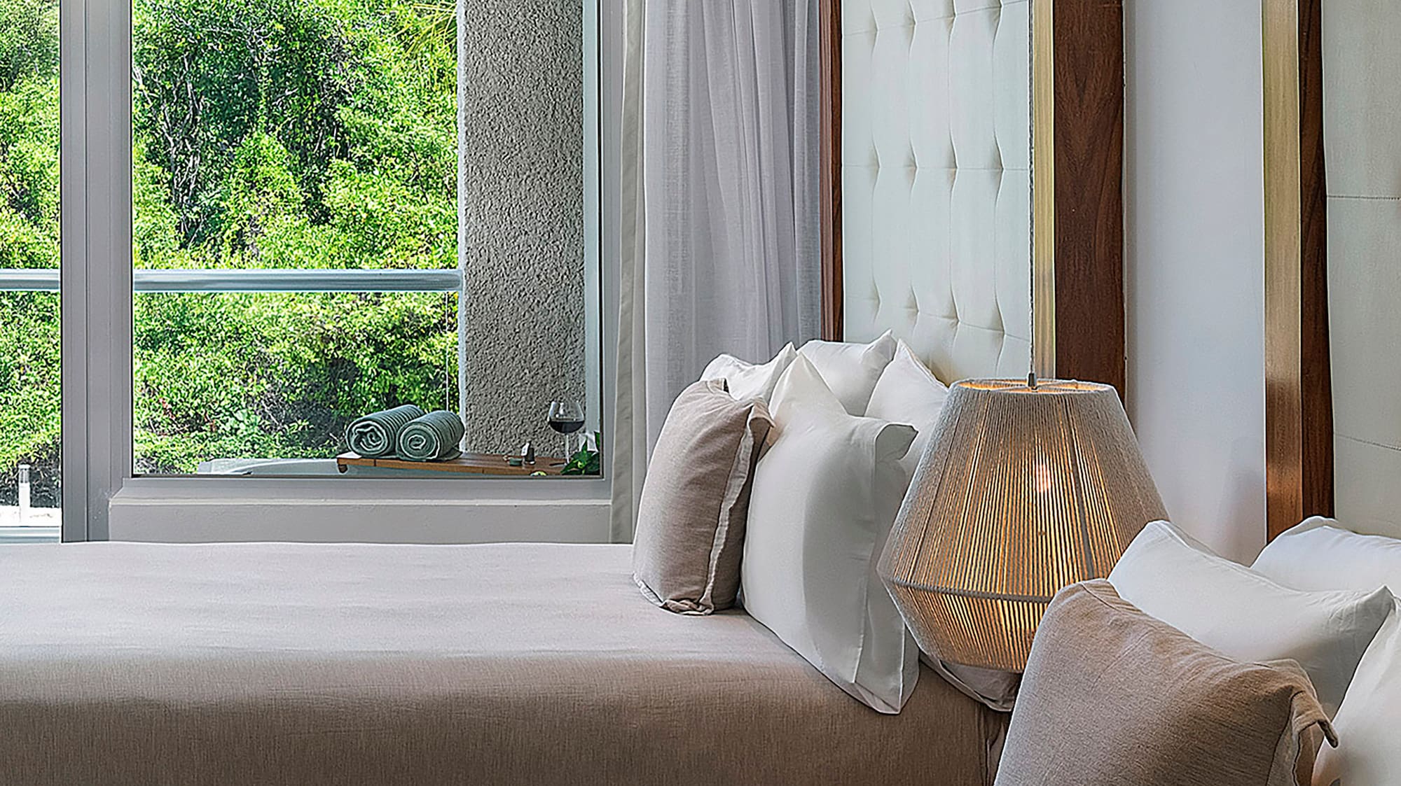 a room with two beds and a lamp