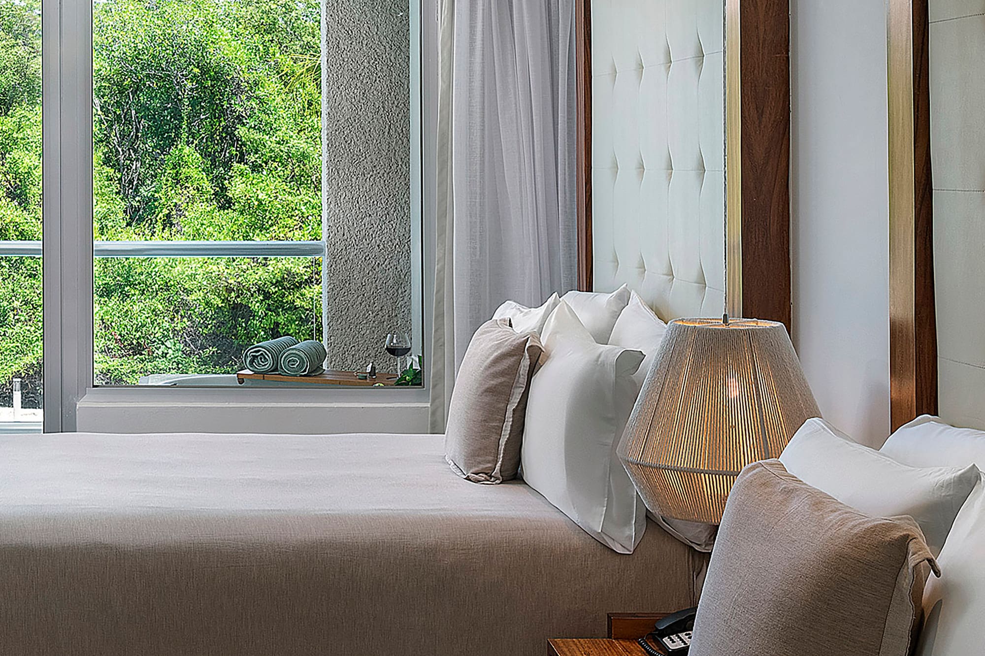 a room with two beds and a lamp