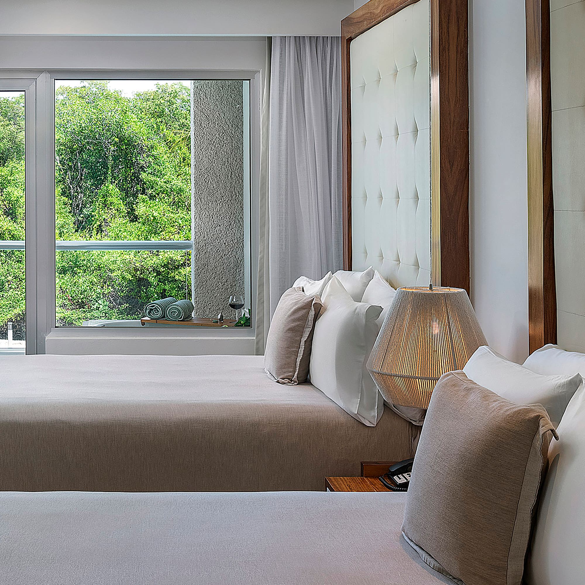 a room with two beds and a lamp