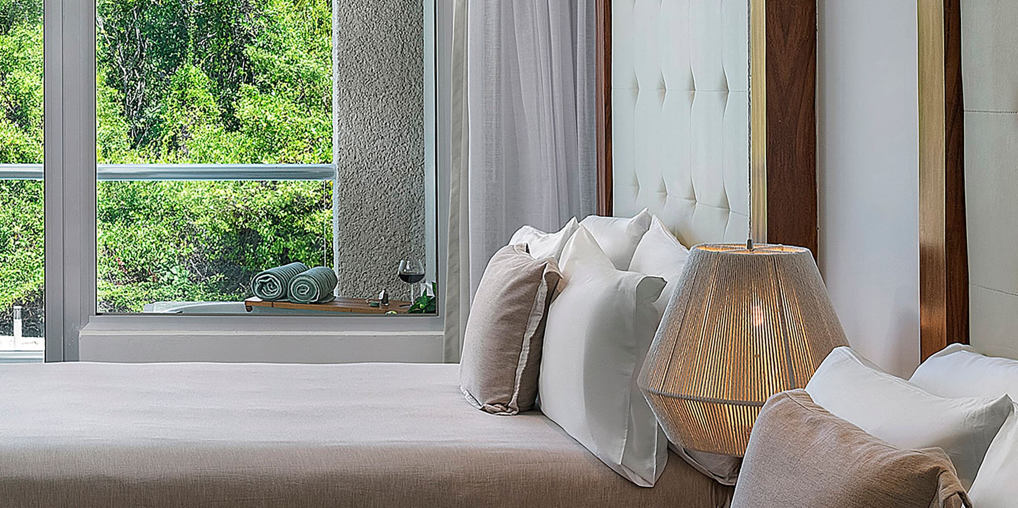 a room with two beds and a lamp