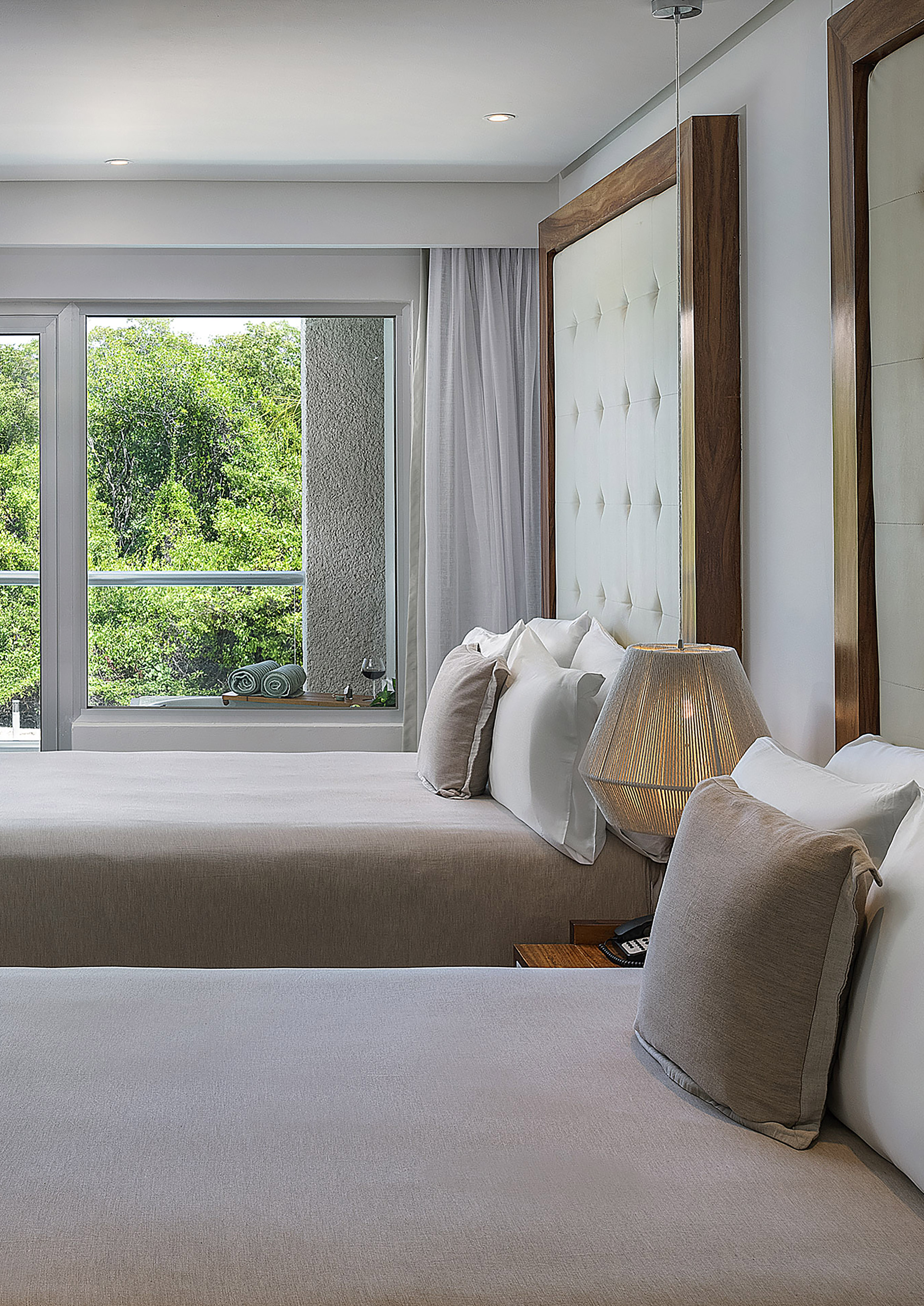 a room with two beds and a lamp