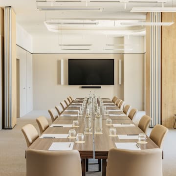 a conference room with a table and chairs