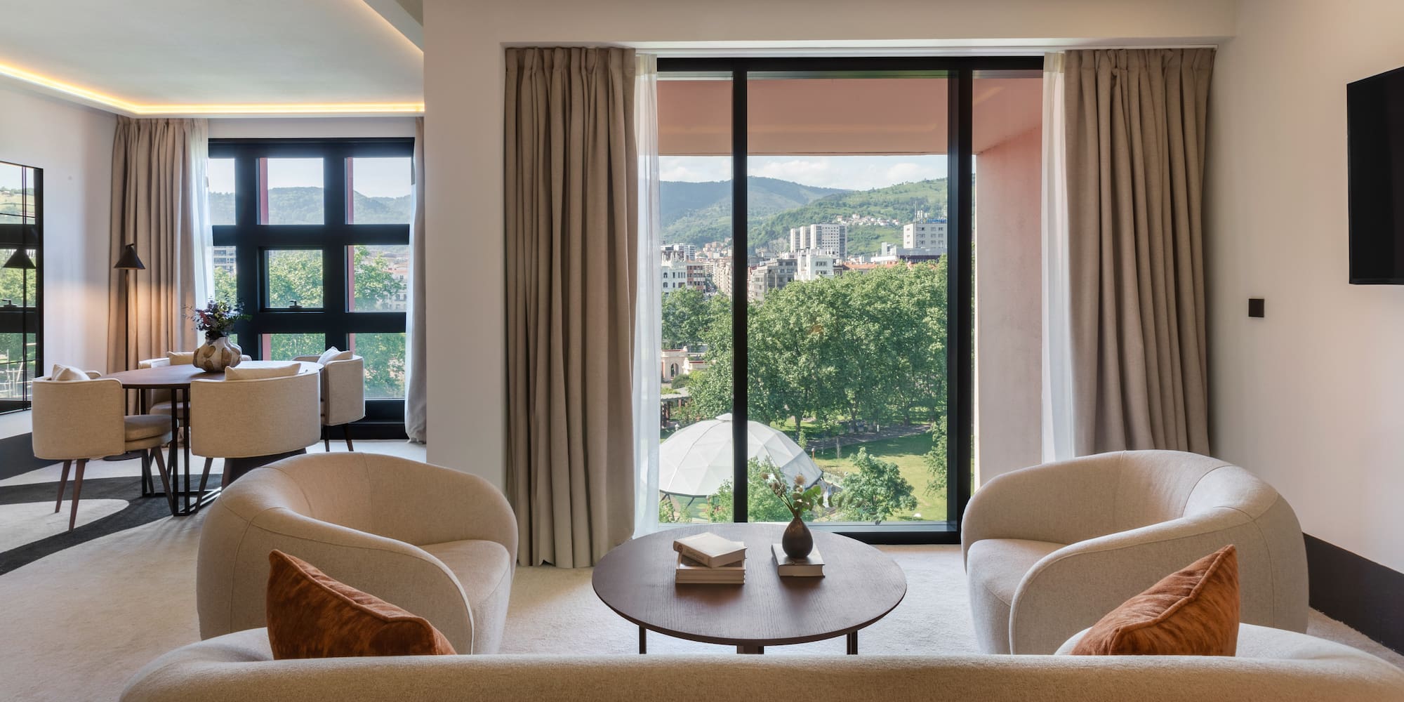 a living room with a view of the city from the window