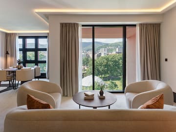 a living room with a view of the city from the window