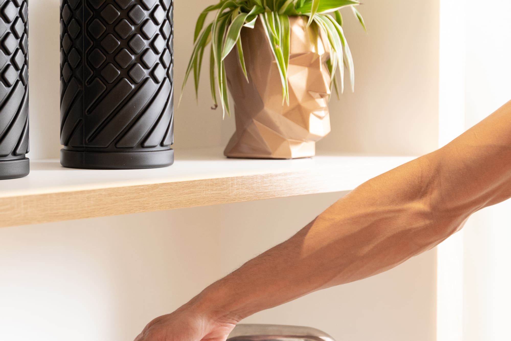 a person's hand on a metal bar