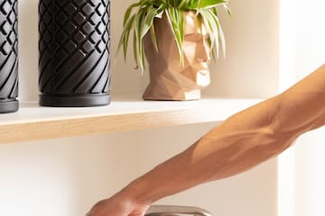 a person's hand on a metal bar