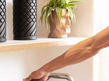 a person's hand on a metal bar