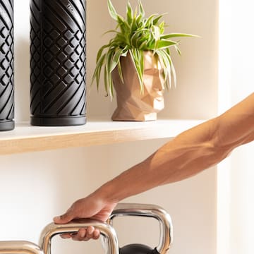a person's hand on a metal bar