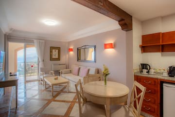 a living room with a table and chairs