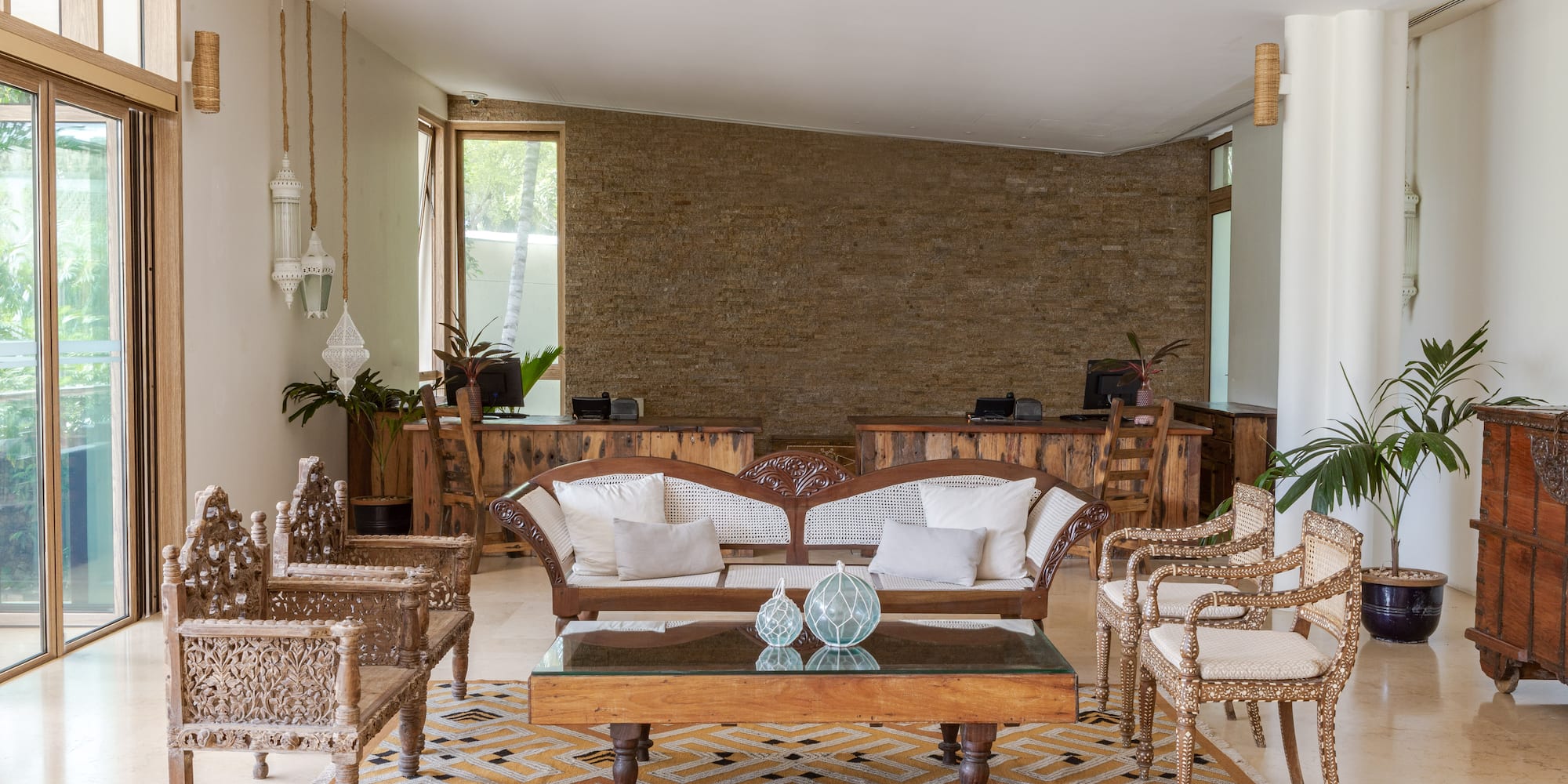 a room with a couch and chairs