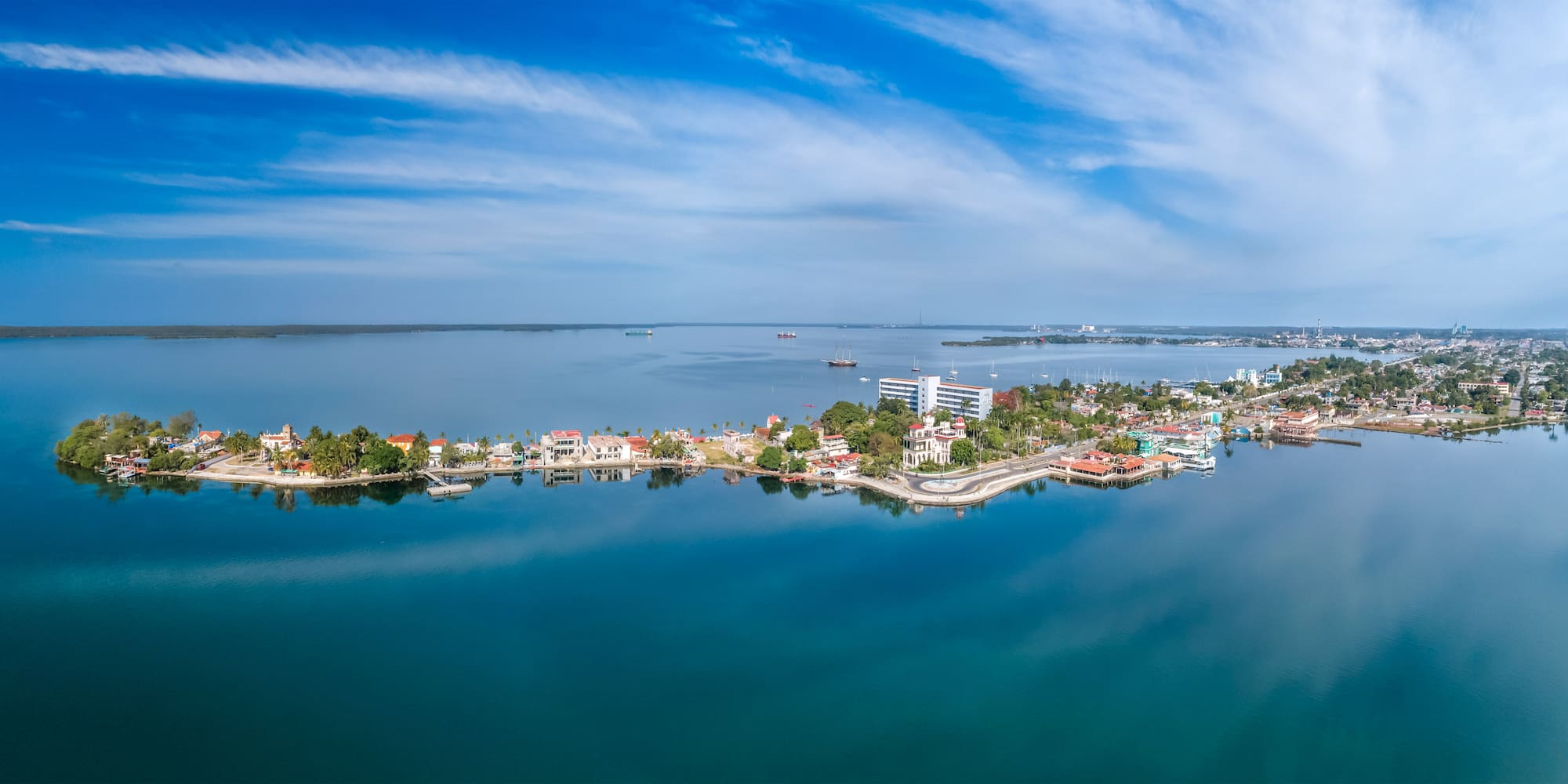 a body of water with buildings and boats in the background
